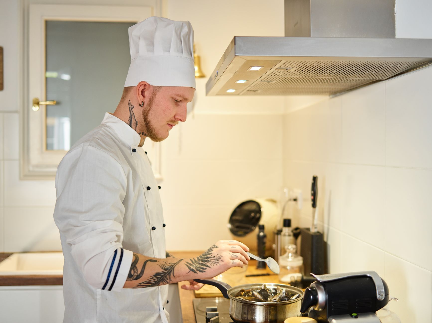 chef in clean white jacket in a professional kitchen — CanDo Laundry Services