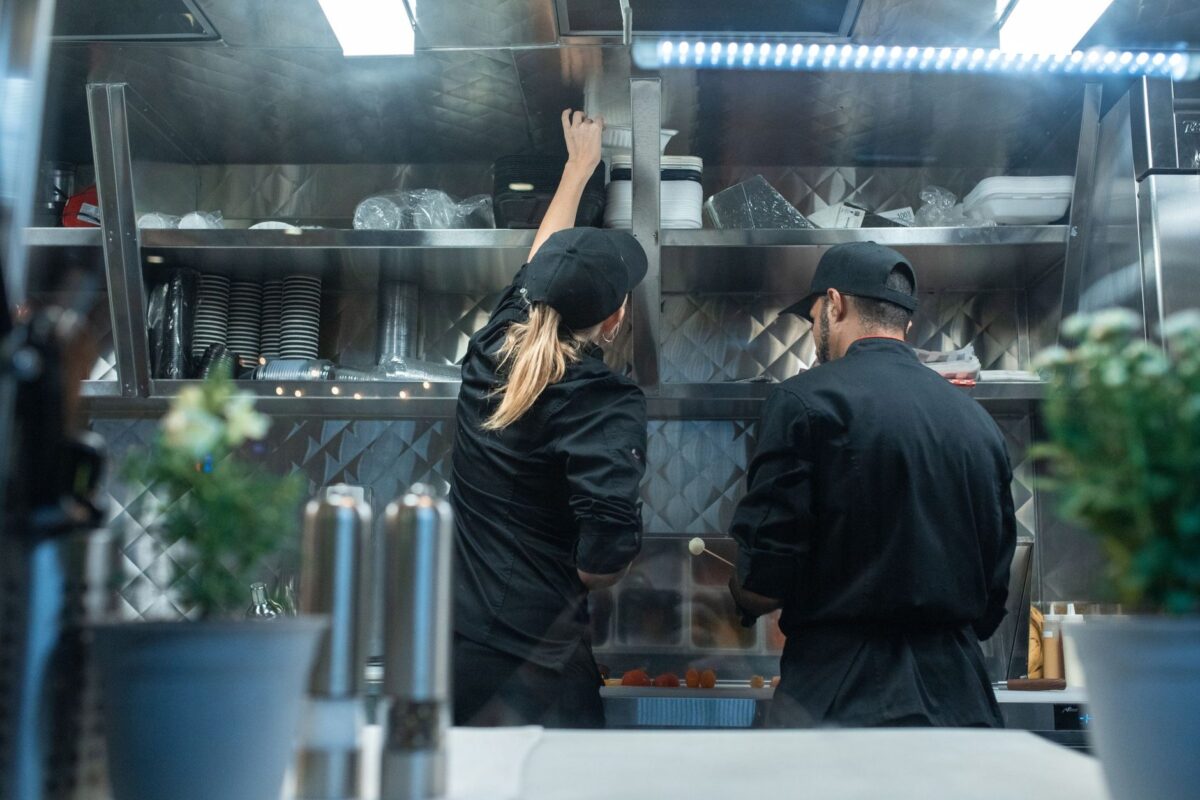 Chefs standing at work in a commercial kitchen