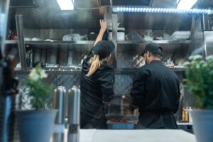 Chefs standing at work in a commercial kitchen