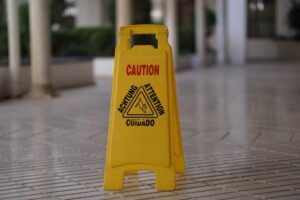 Caution wet floor sign on a tiled commercial entrance floor