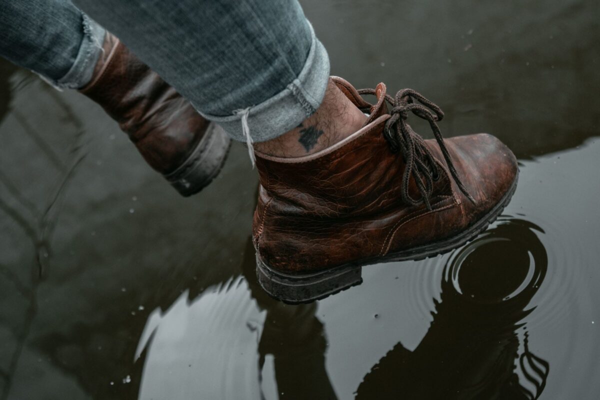 Boots stepping through a puddle on the way in
