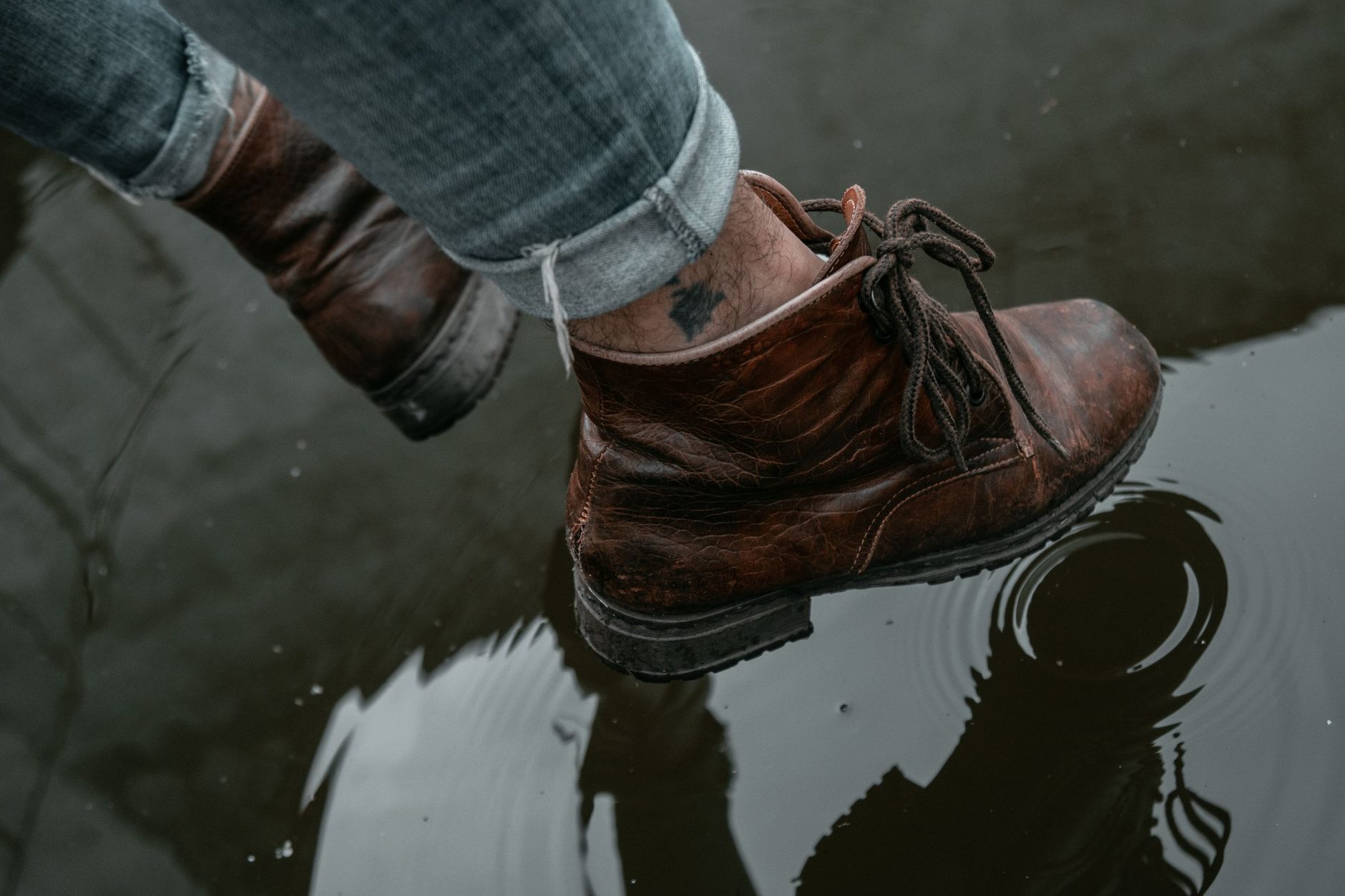Boots stepping through a puddle on the way in
